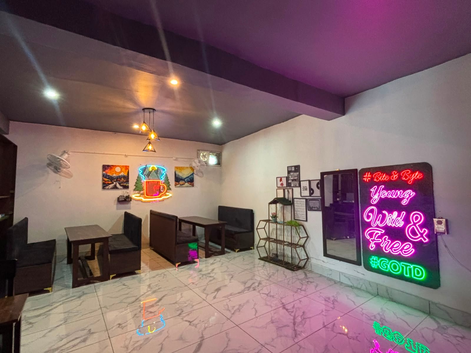Bite & Byte neon-lit gaming lounge seating area in Jawali
